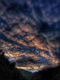 Low angle view of dramatic sky during sunset