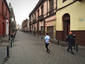 People walking on street in city