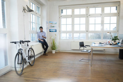 Man using cell phone in a modern informal office