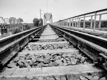 Surface level of railroad tracks against the sky