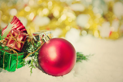 Close-up of red bauble on fake snow