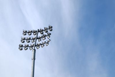 Low angle view of lighting equipment against sky