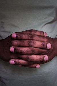 Close-up of hands clasped