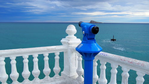 Telescope at observation point in front of sea