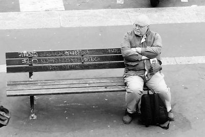 Full length of man sitting on road