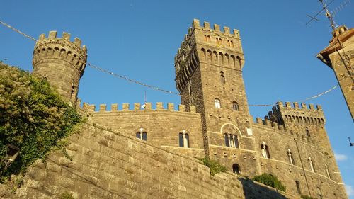 Low angle view of historic building against blue sky