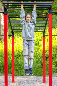 Portrait of young man exercising in playground