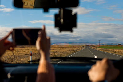 Cropped image person taking selfie in car