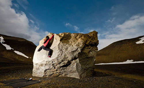 Woman bouldering on rock in rural iceland