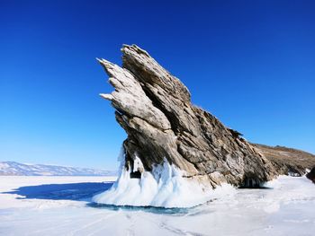 Scenic view of snowcapped mountains against clear blue sky