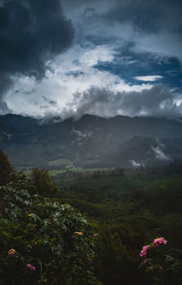 Scenic view of sea and mountains against sky