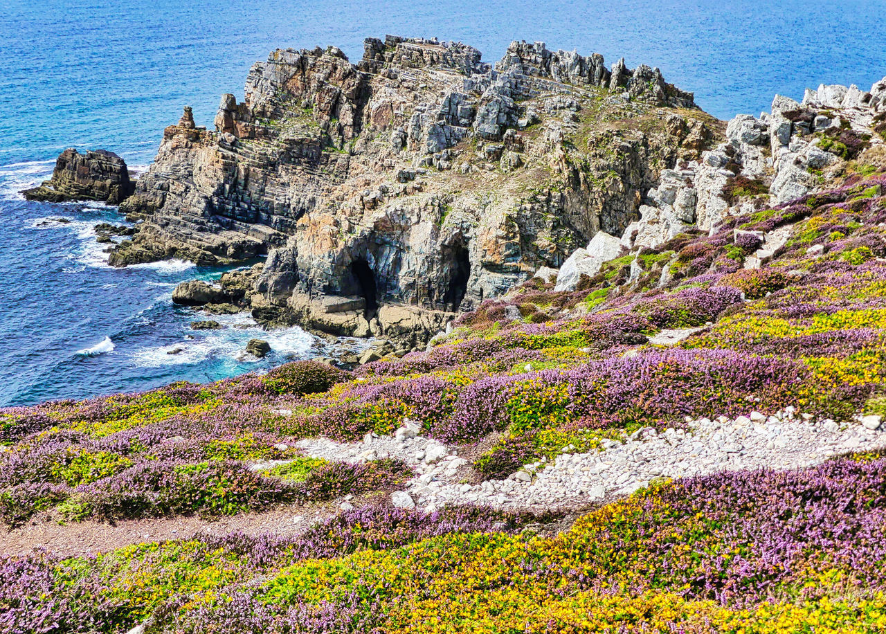 SCENIC VIEW OF SEA BY ROCK FORMATION ON SHORE