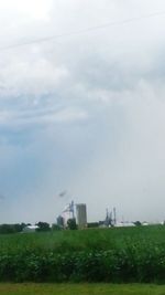 Scenic view of field against cloudy sky