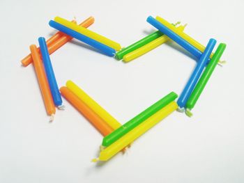 High angle view of colored pencils on white background