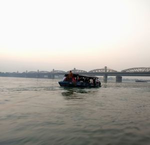 Boat in river at sunset