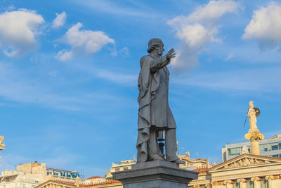 Low angle view of statue against cloudy sky