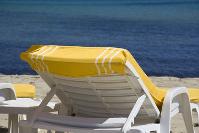 Close-up of chairs on beach