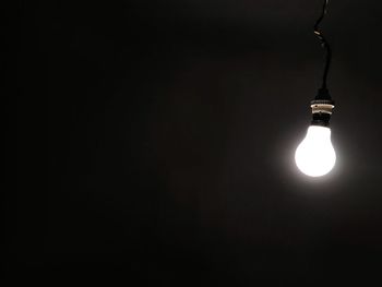 Low angle view of illuminated light bulb