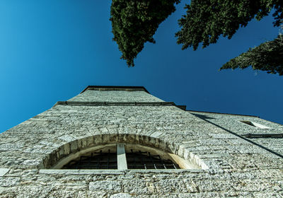 Low angle view of building against clear blue sky