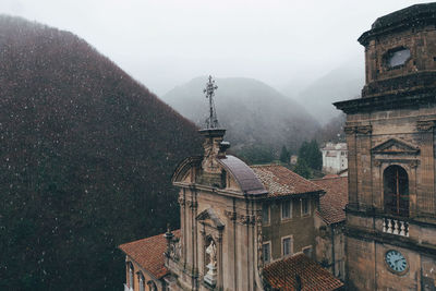 Panoramic view of building and mountains against sky