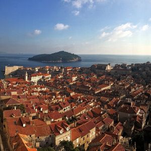 Dubrovnik city center- high angle view of townscape by sea against sky