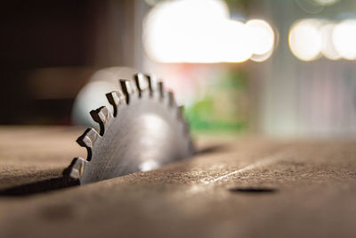 Close-up of illuminated light bulb on table