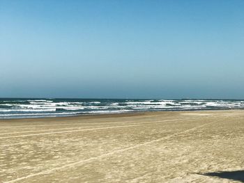 Scenic view of beach against clear sky