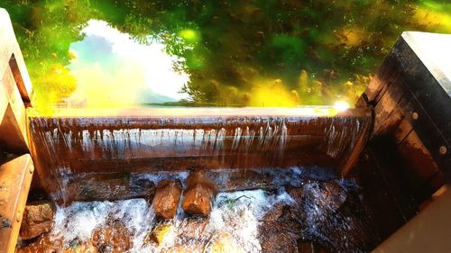 High angle view of water flowing through wood