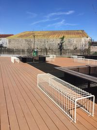 View of empty boardwalk against blue sky