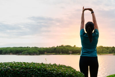 Sport woman is stretching muscle after workout