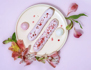 High angle view of pink roses over white background