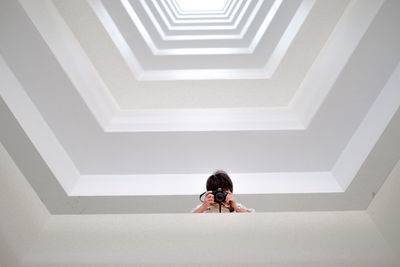 High angle view of woman walking on staircase