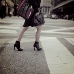 Side view low section of woman walking on street