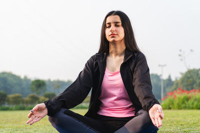 Young indian girl meditating in the park early in the morning. girl working out in the morning. 