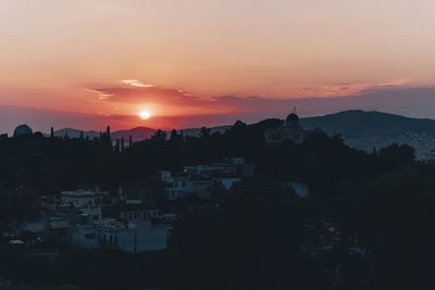 Cityscape against sky at sunset