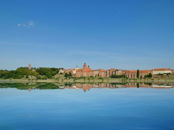 View of lake against blue sky