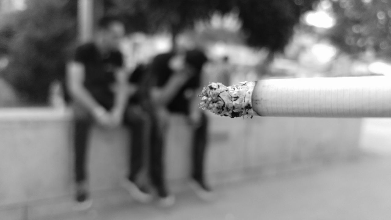 CLOSE-UP OF A CIGARETTE ON WOOD