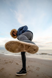 Full length of man on sand at beach against sky