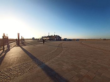 Scenic view of beach against clear blue sky