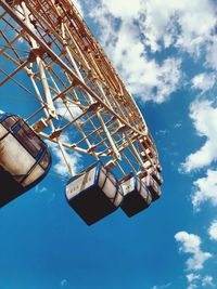 Low angle view of ferris wheel against blue sky