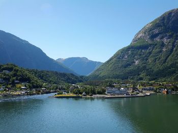 Scenic view of lake and mountains against clear sky