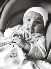 Portrait of cute baby girl in stroller