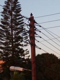 Low angle view of telephone pole against clear sky