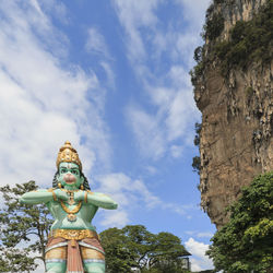 Low angle view of statue against sky