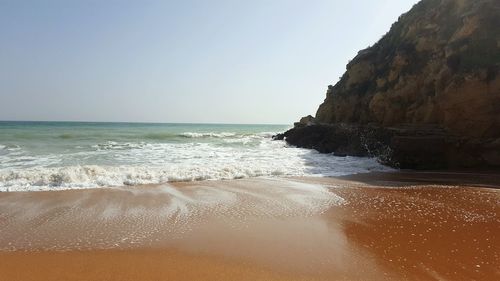 Scenic view of beach against clear sky