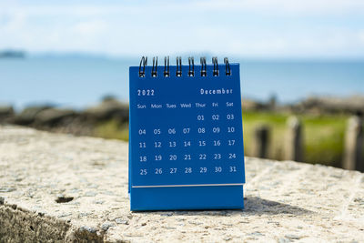 Blue december 2022 calendar on blurred background of blue ocean. 2022 new year concept