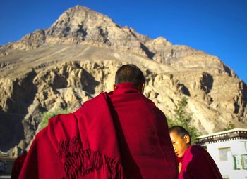 Rear view of couple on mountain against sky