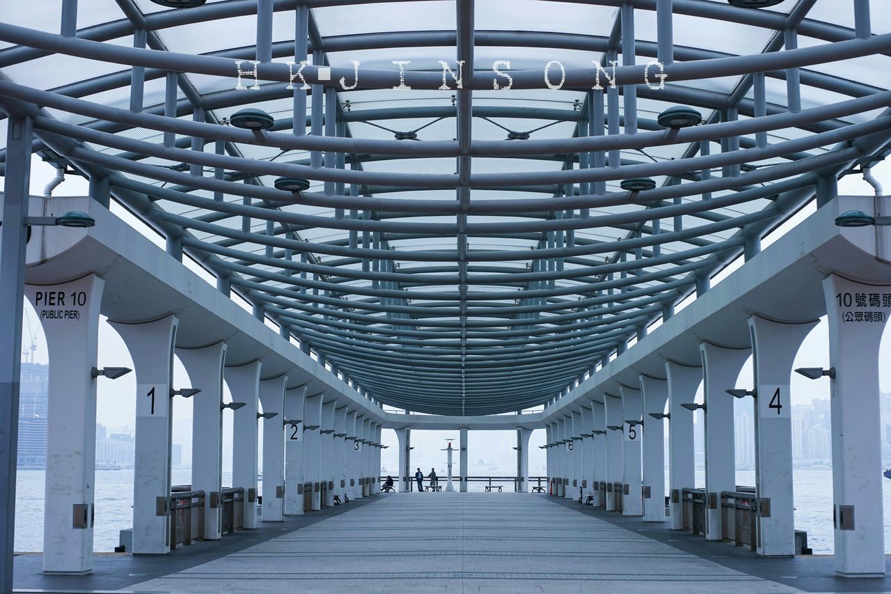 architecture, built structure, indoors, ceiling, the way forward, diminishing perspective, corridor, in a row, architectural column, railing, empty, column, vanishing point, architectural feature, pattern, repetition, modern, day, long, colonnade