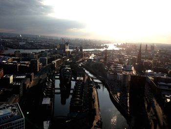 High angle view of city buildings against sky during sunset