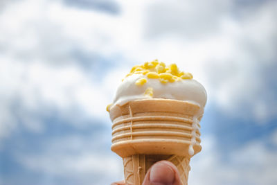 Close-up of hand holding ice cream against blurred background